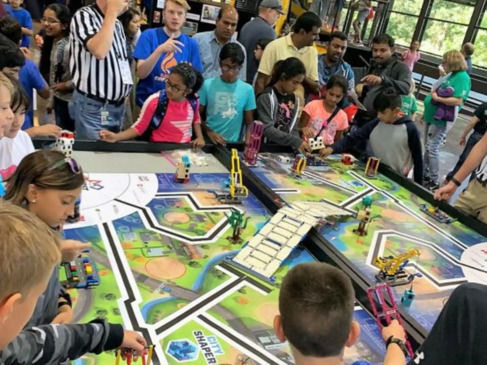 a group of people sitting around a table with a board game