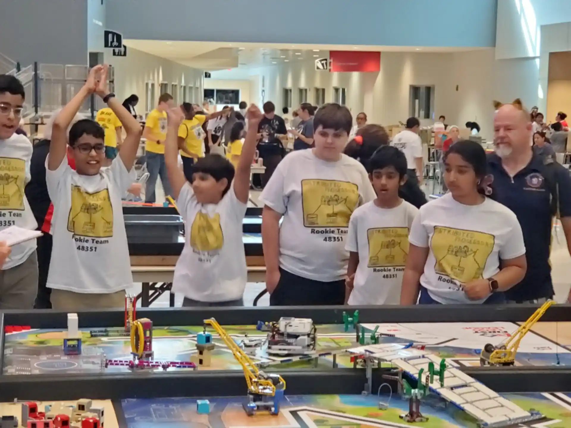 a group of people standing around a table with a game board
