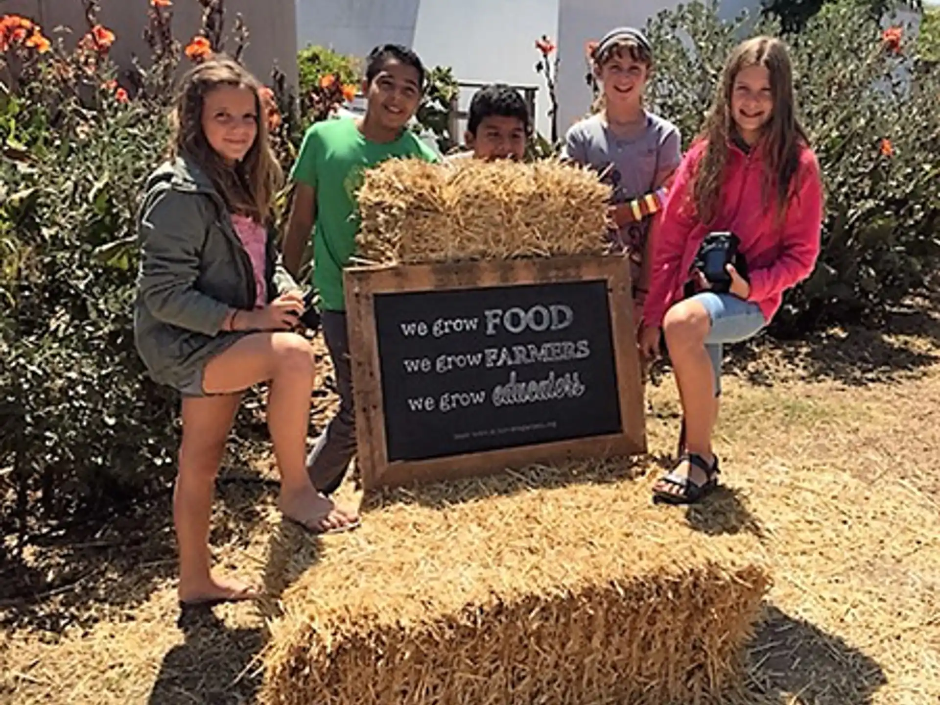 a group of people posing for a photo next to a sign