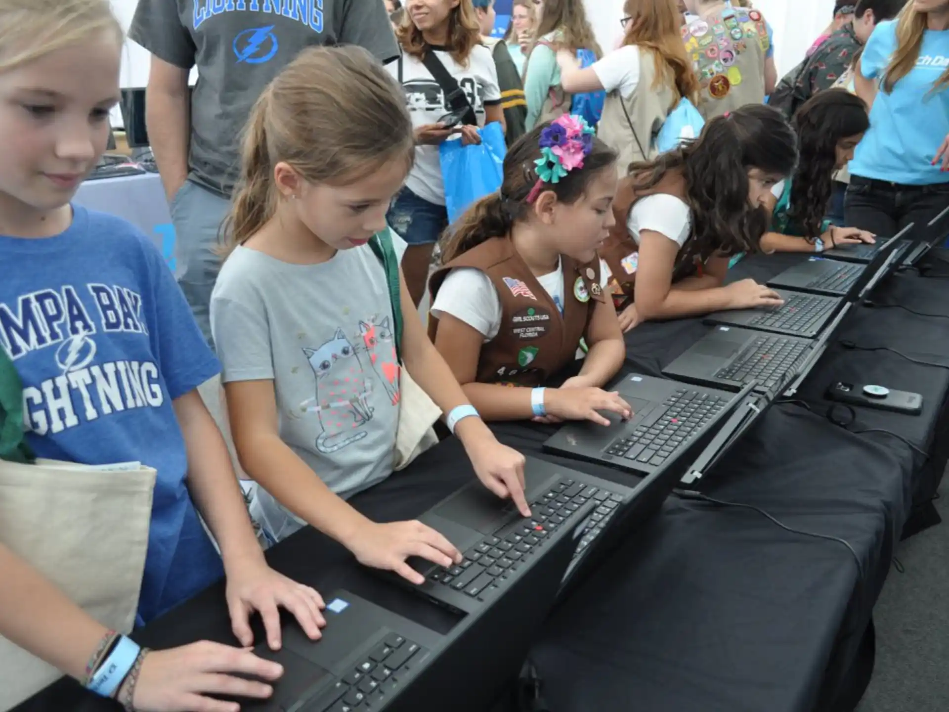 a group of children using a laptop