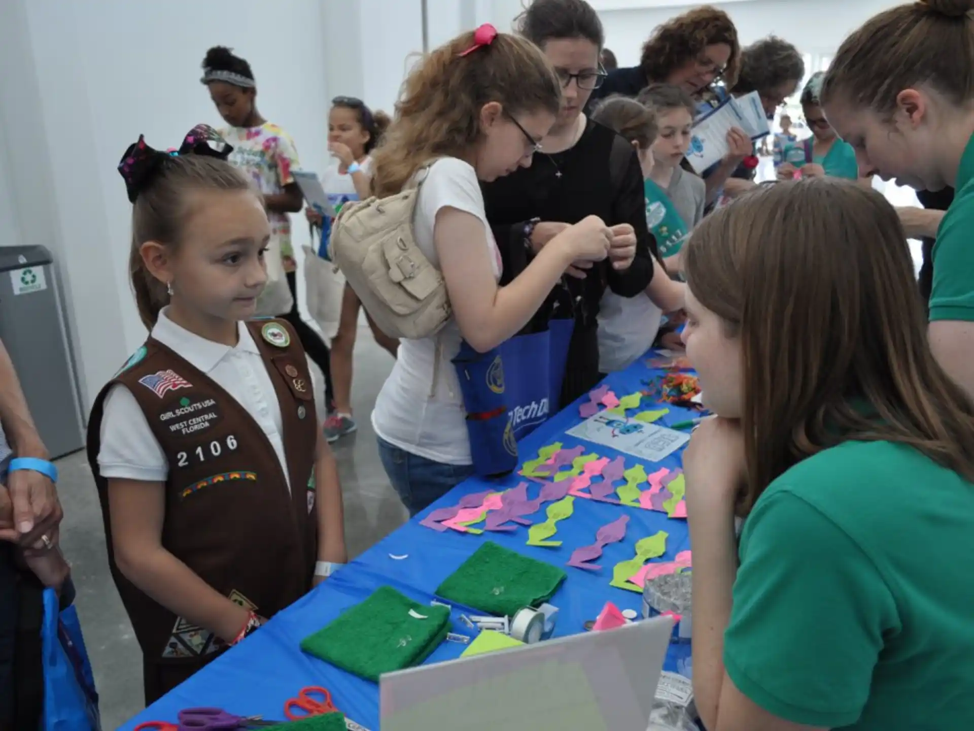 a group of people looking at a green object on a table