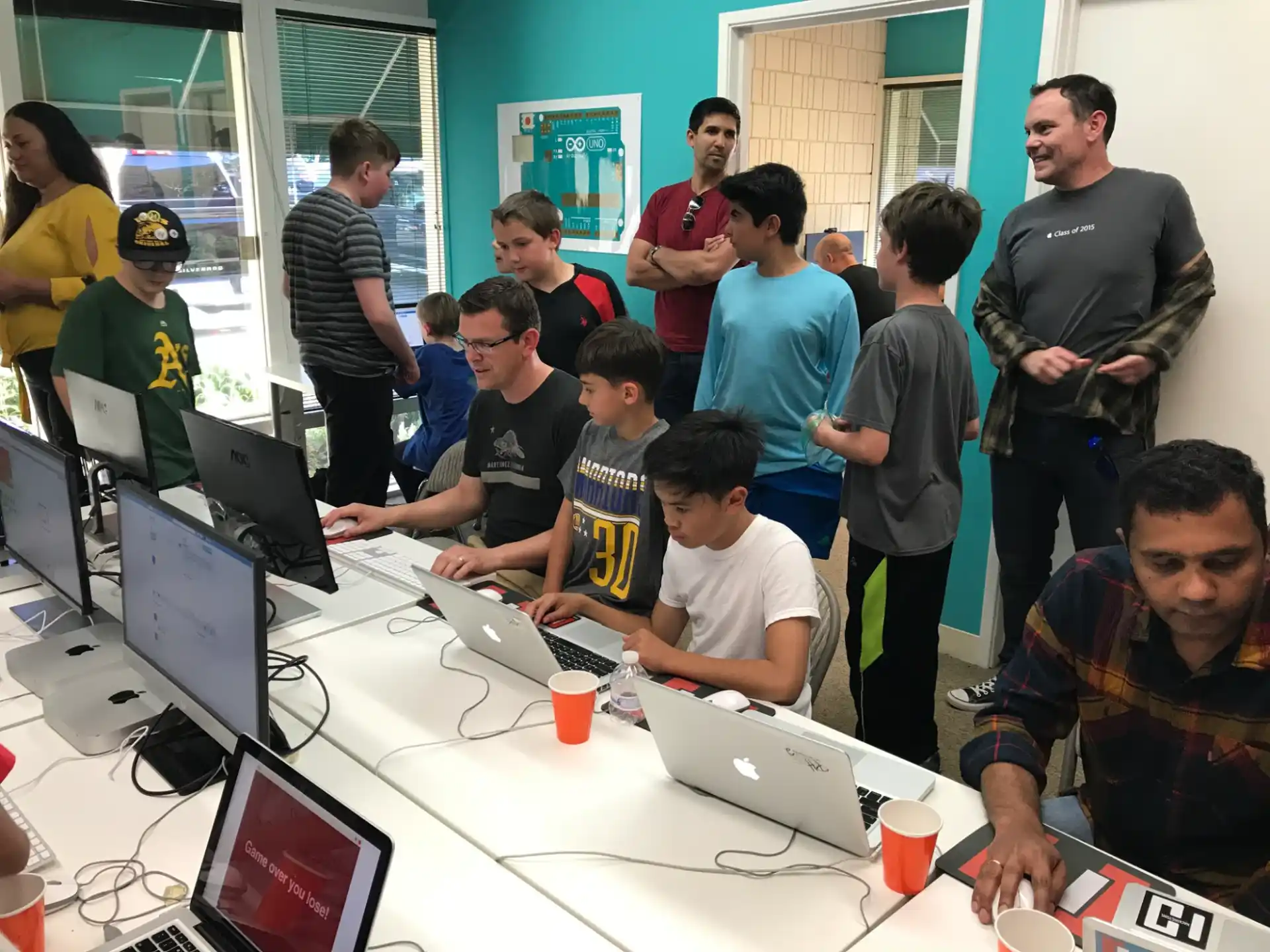 a group of people looking at laptops