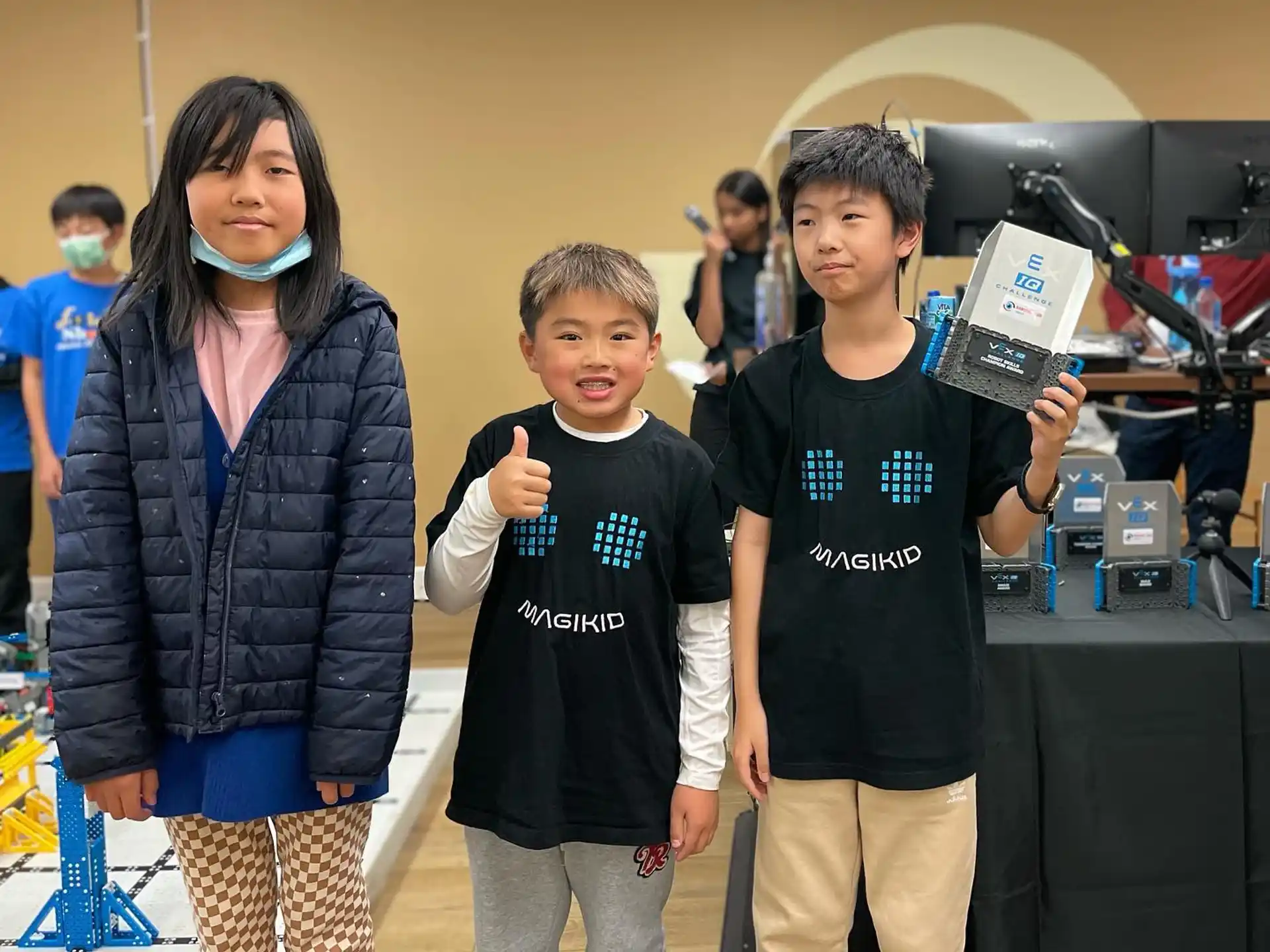 a group of kids holding up a trophy