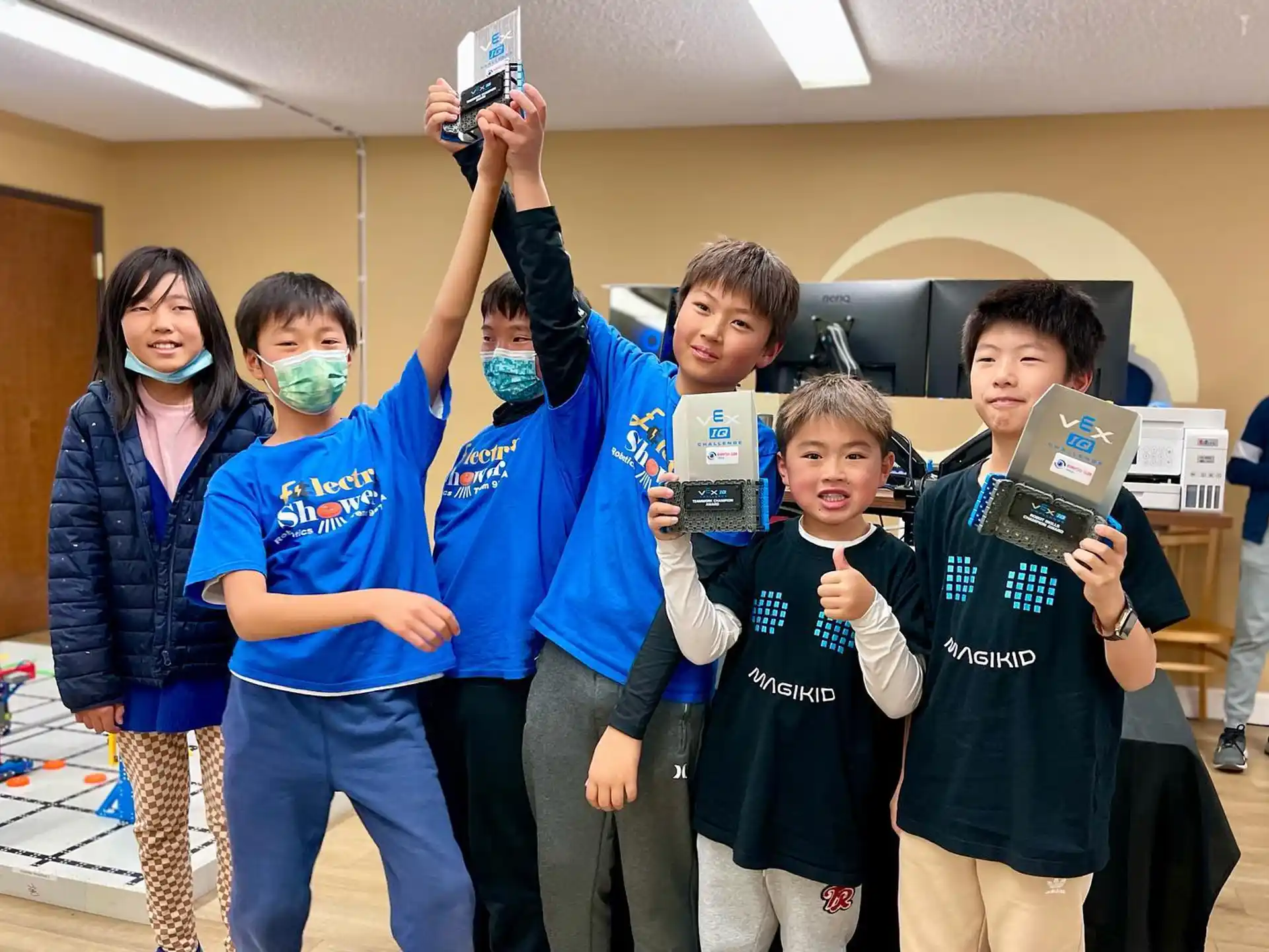 a group of people holding up boxes