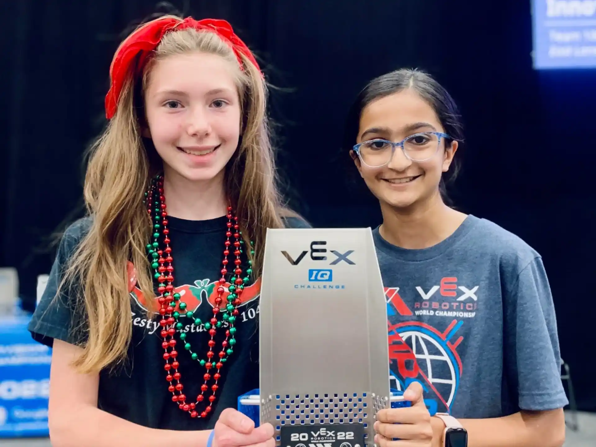 a couple of women holding a plaque