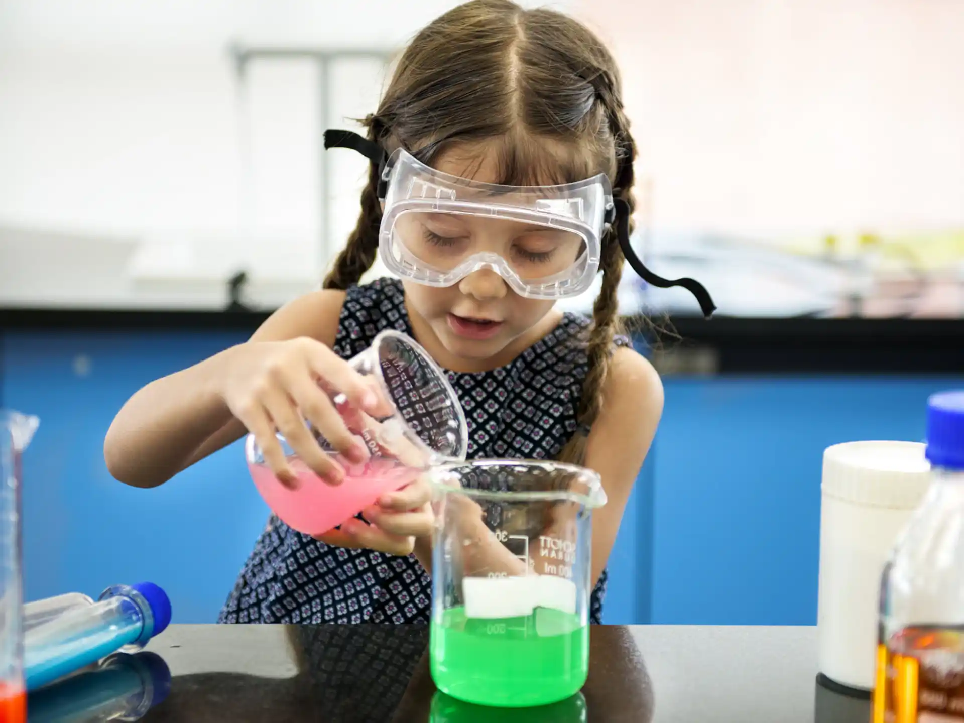 a girl wearing a mask and holding a beaker