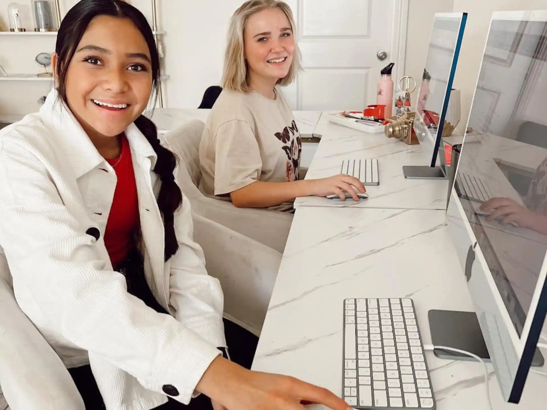 a few women sitting at a computer