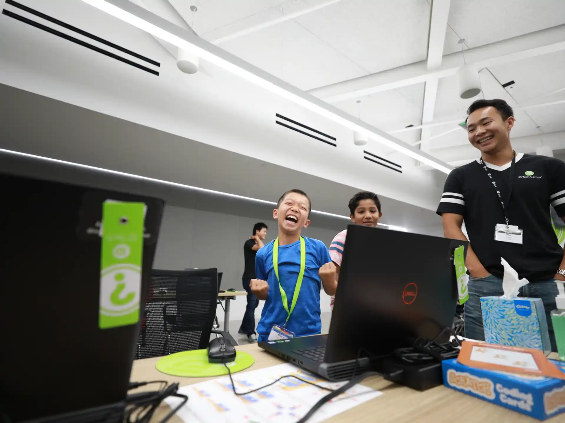 a group of people standing in front of a computer