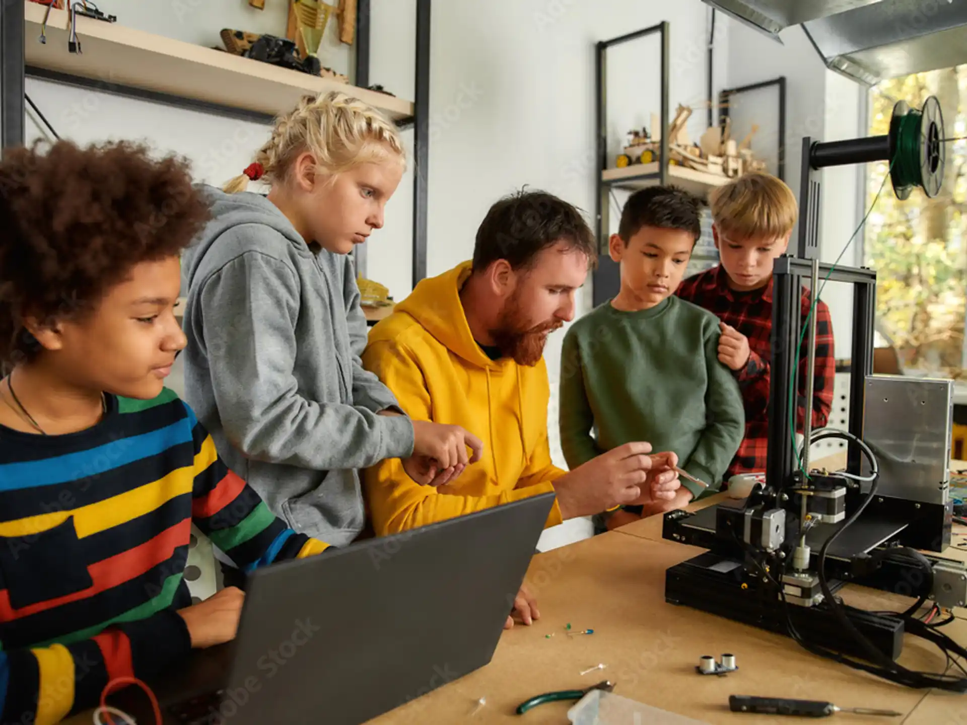 a group of people looking at a laptop