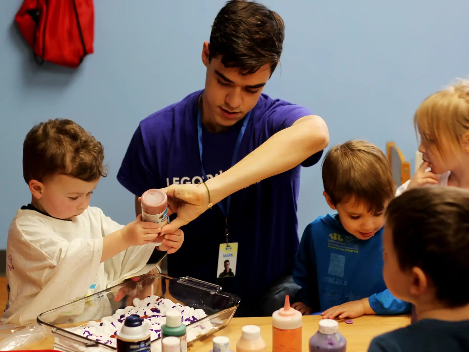 a person helping a group of kids