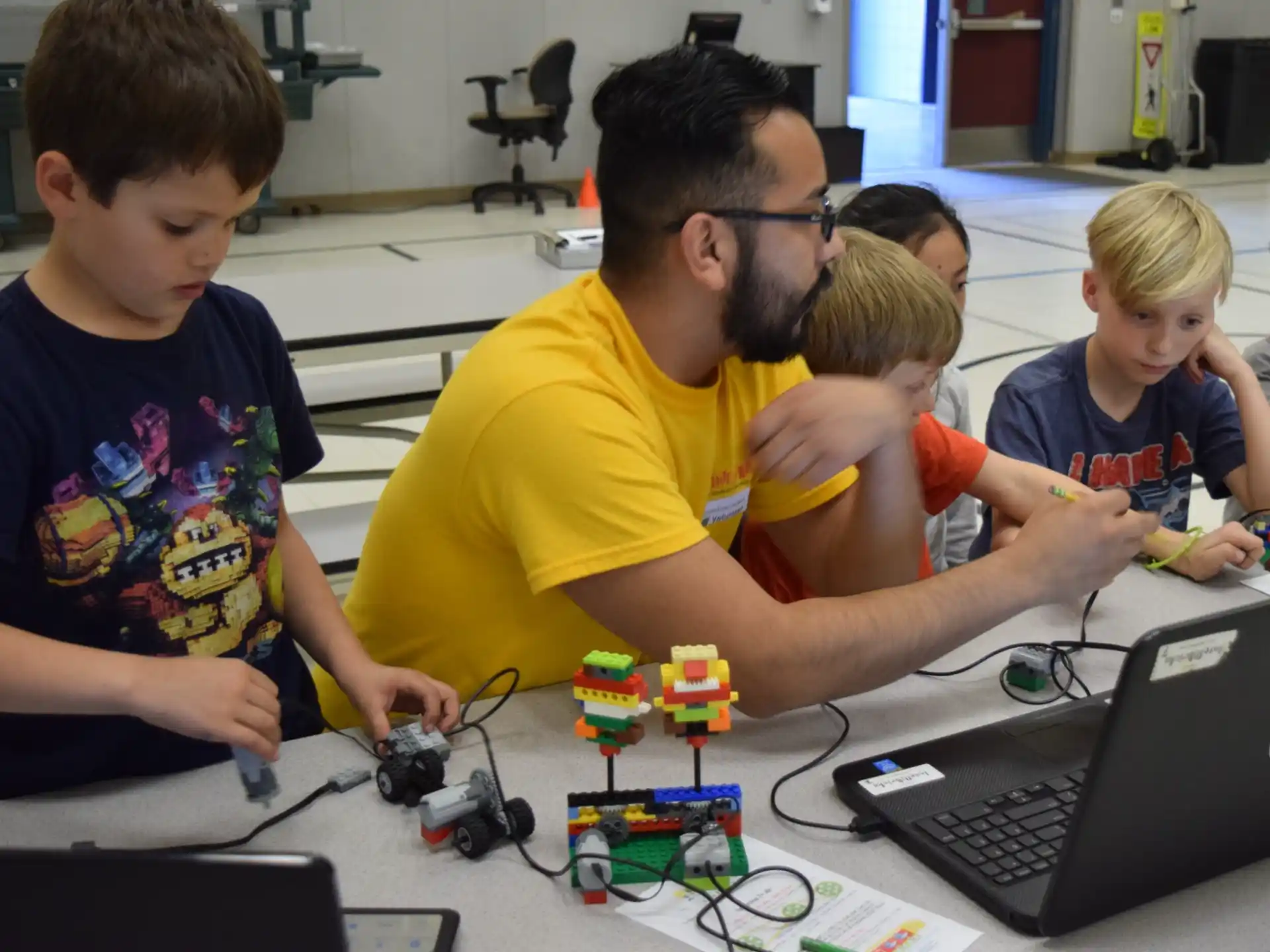 a man and several kids playing with toys