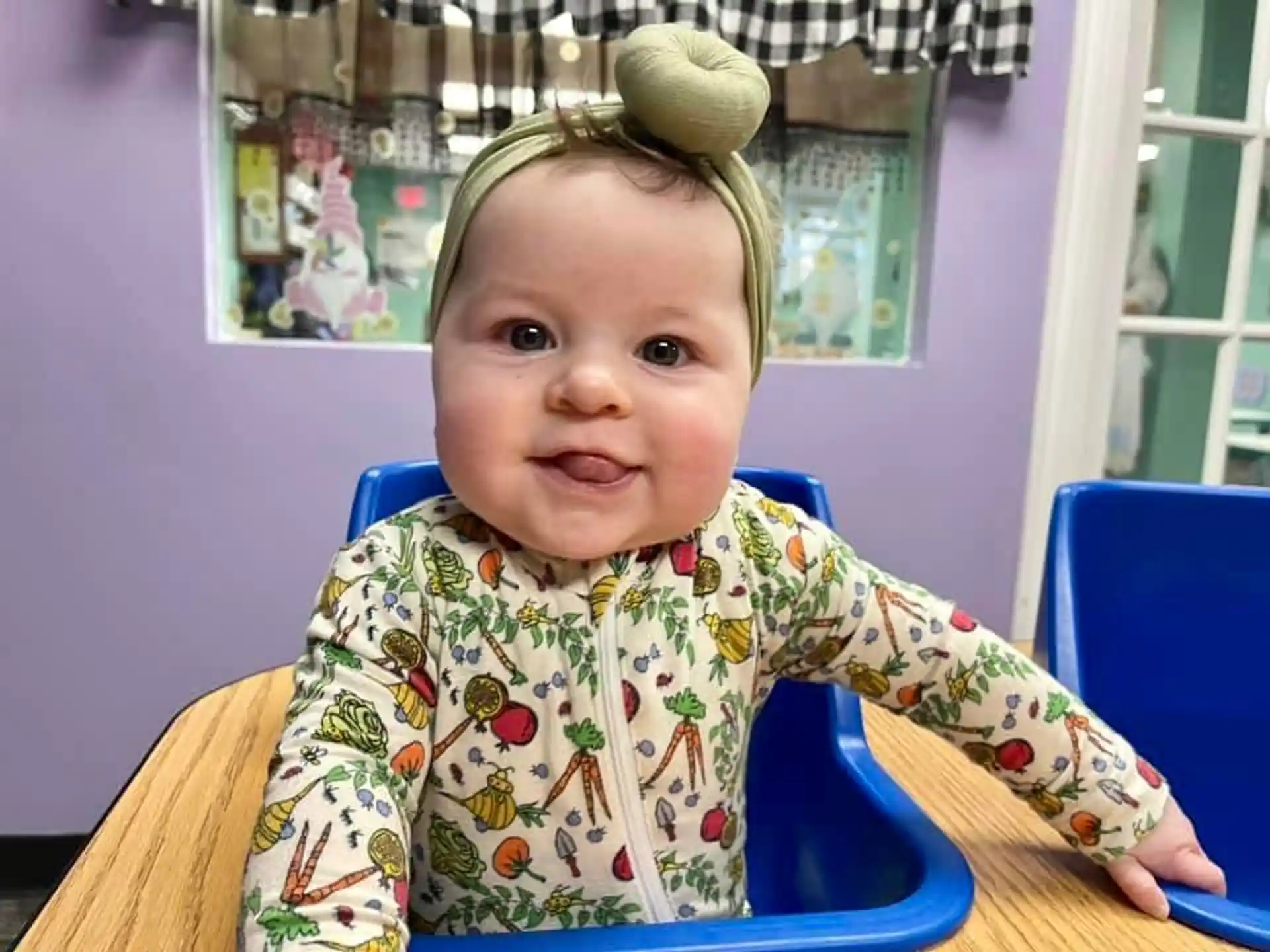 a baby sitting at a table
