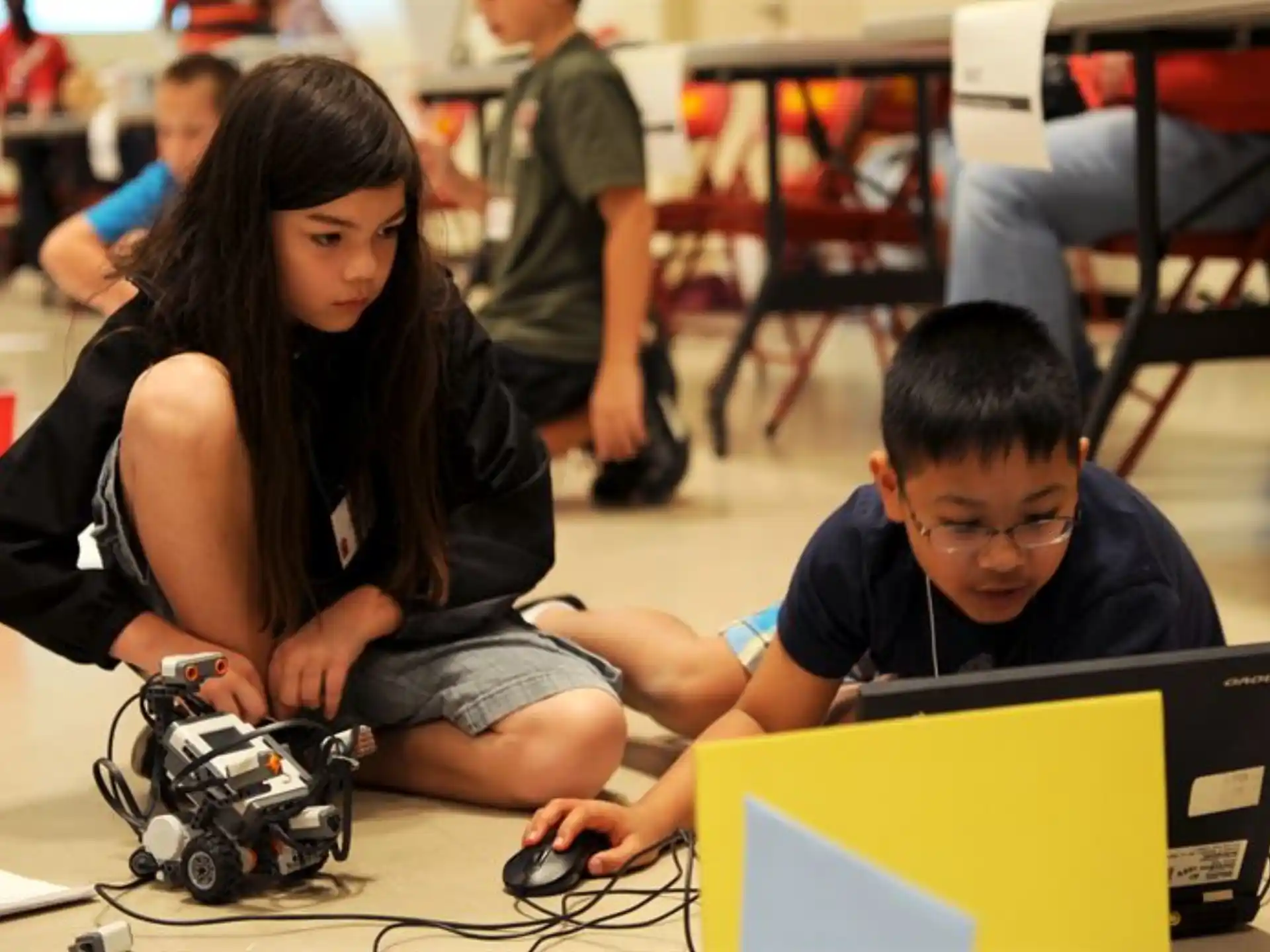 a person and a boy looking at a computer screen