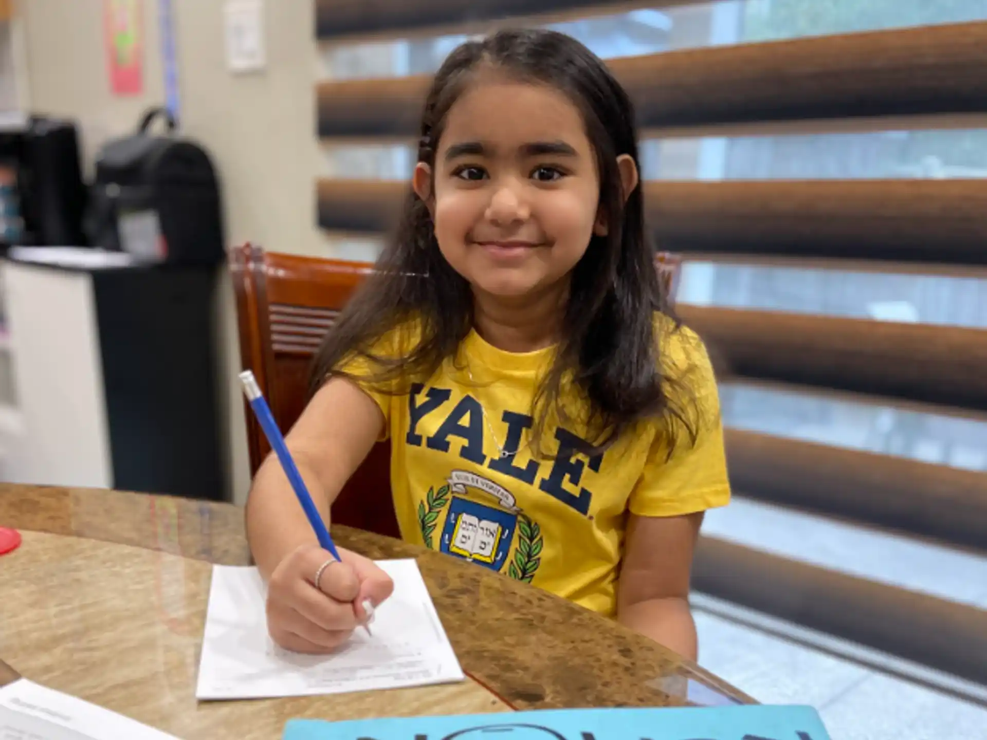 a girl sitting at a table