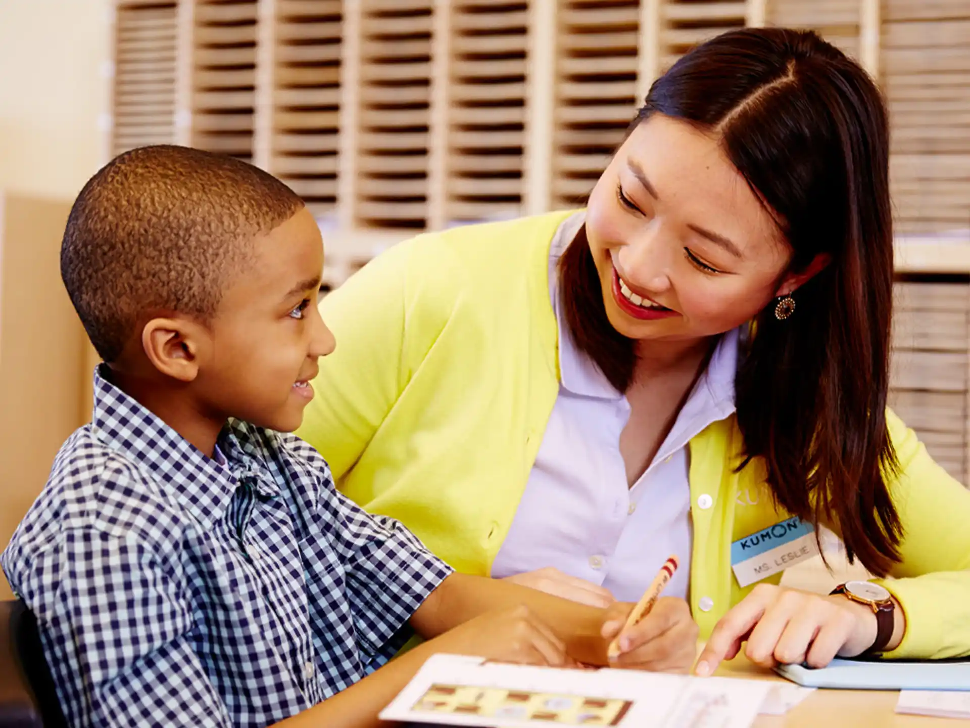 a person and a boy looking at a paper