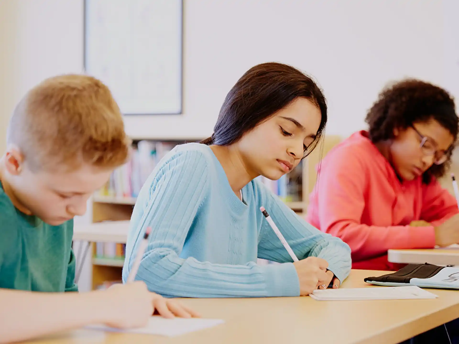 a person and a few children studying