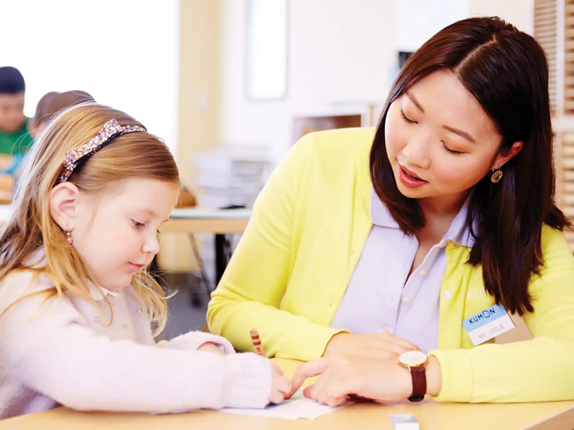 a woman and a girl looking at a paper