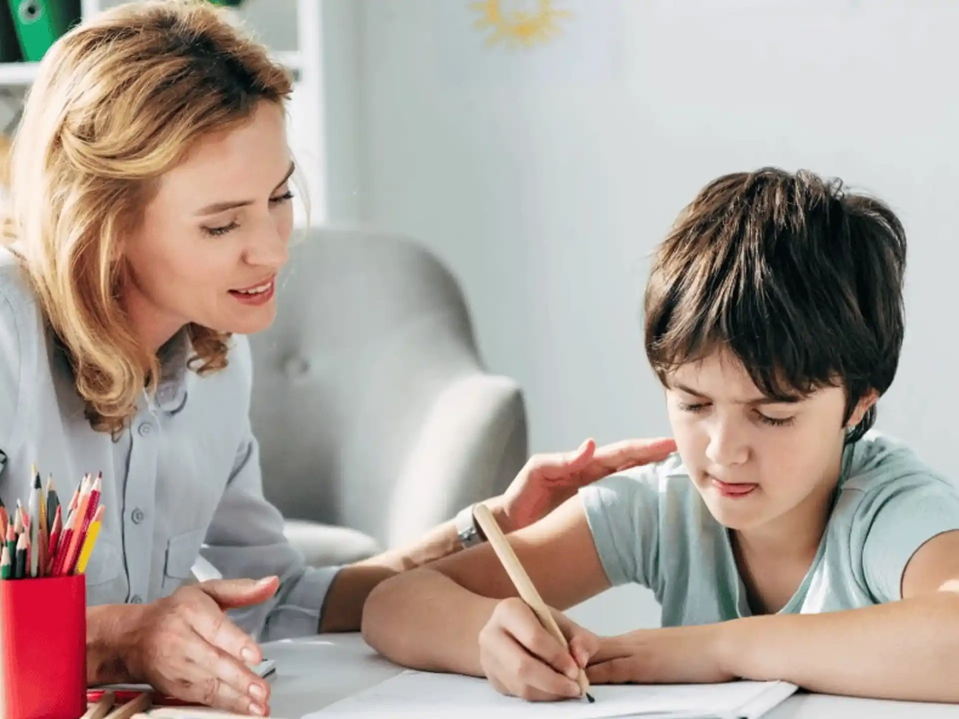a person and a boy sitting at a table
