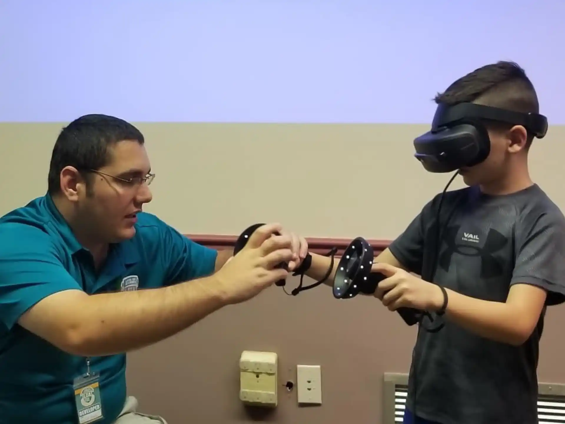 a man holding a camera to a man's head