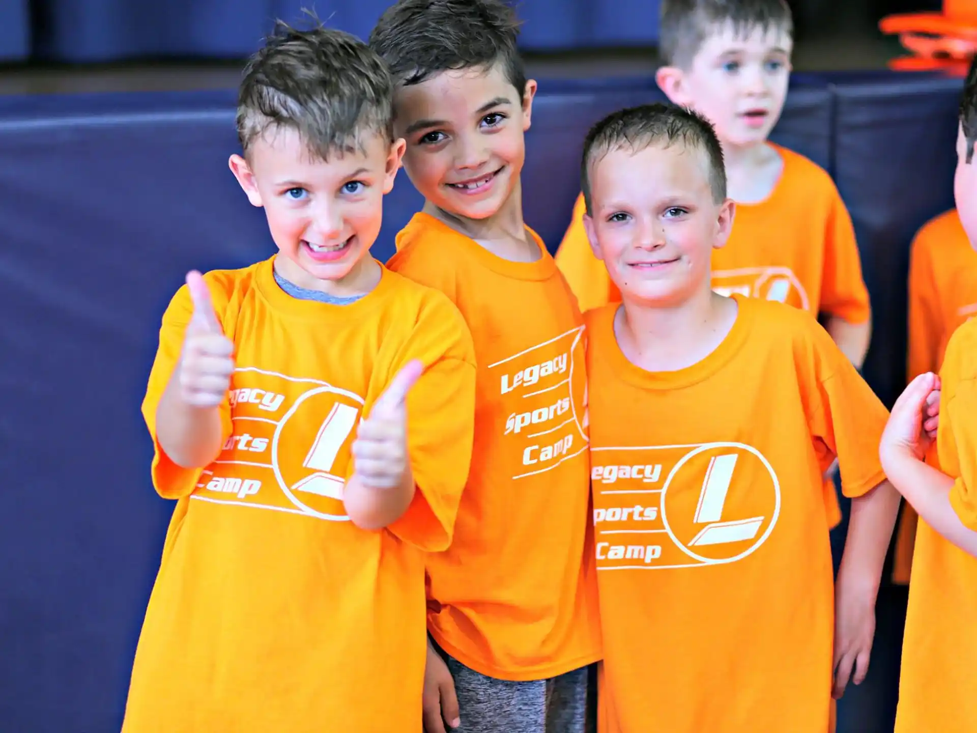 a group of boys in orange shirts