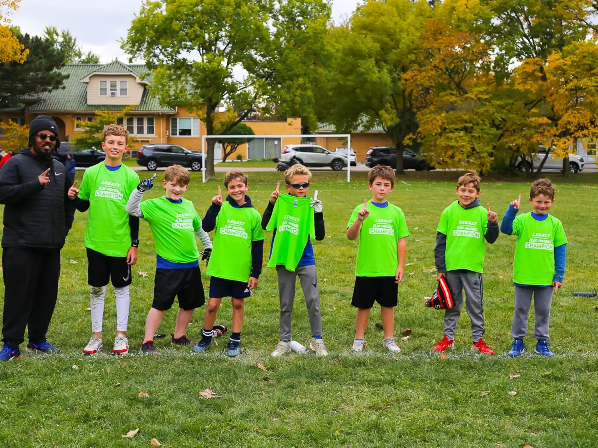 a group of kids in green shirts