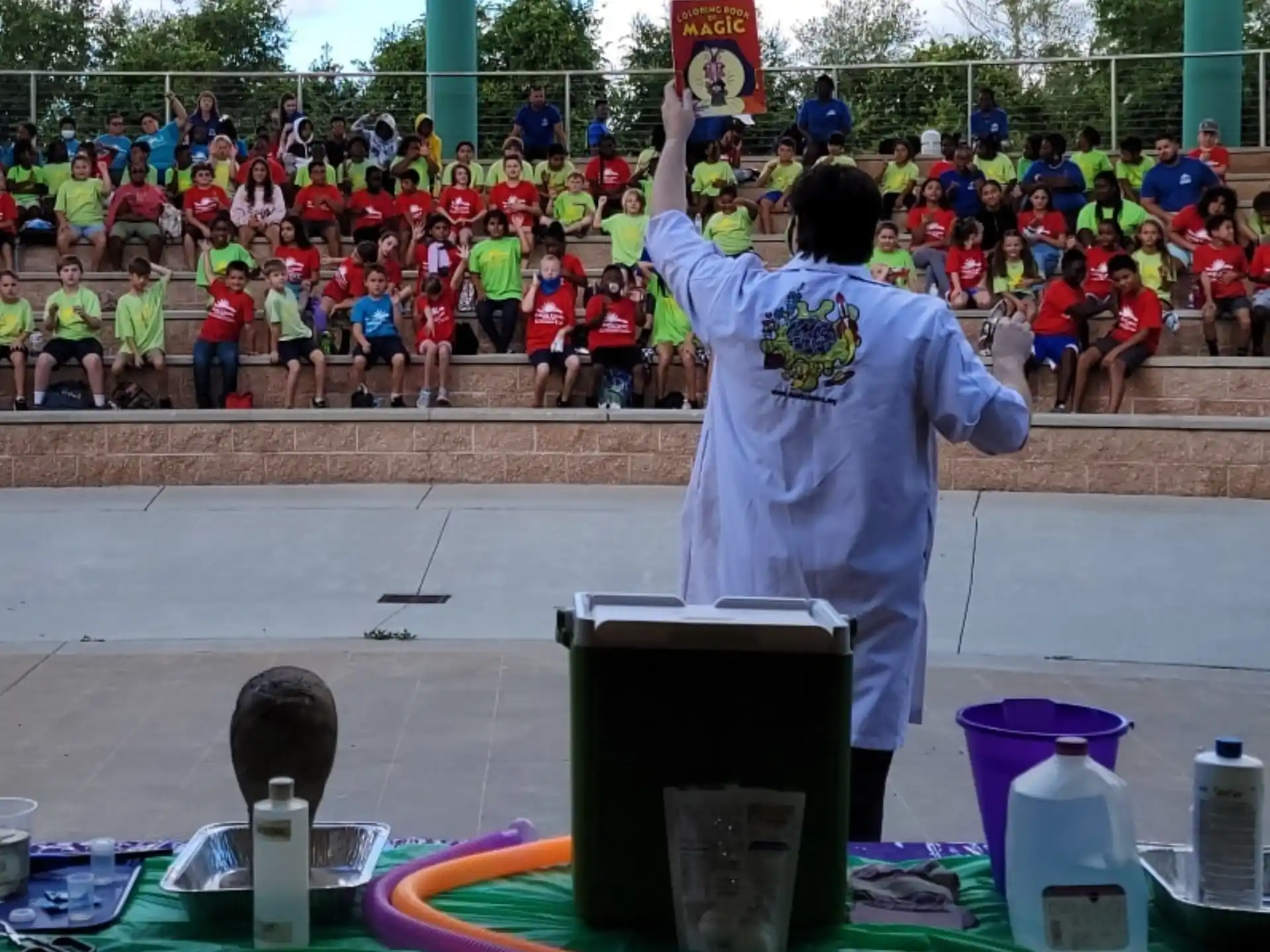 a person standing at a table with a crowd watching