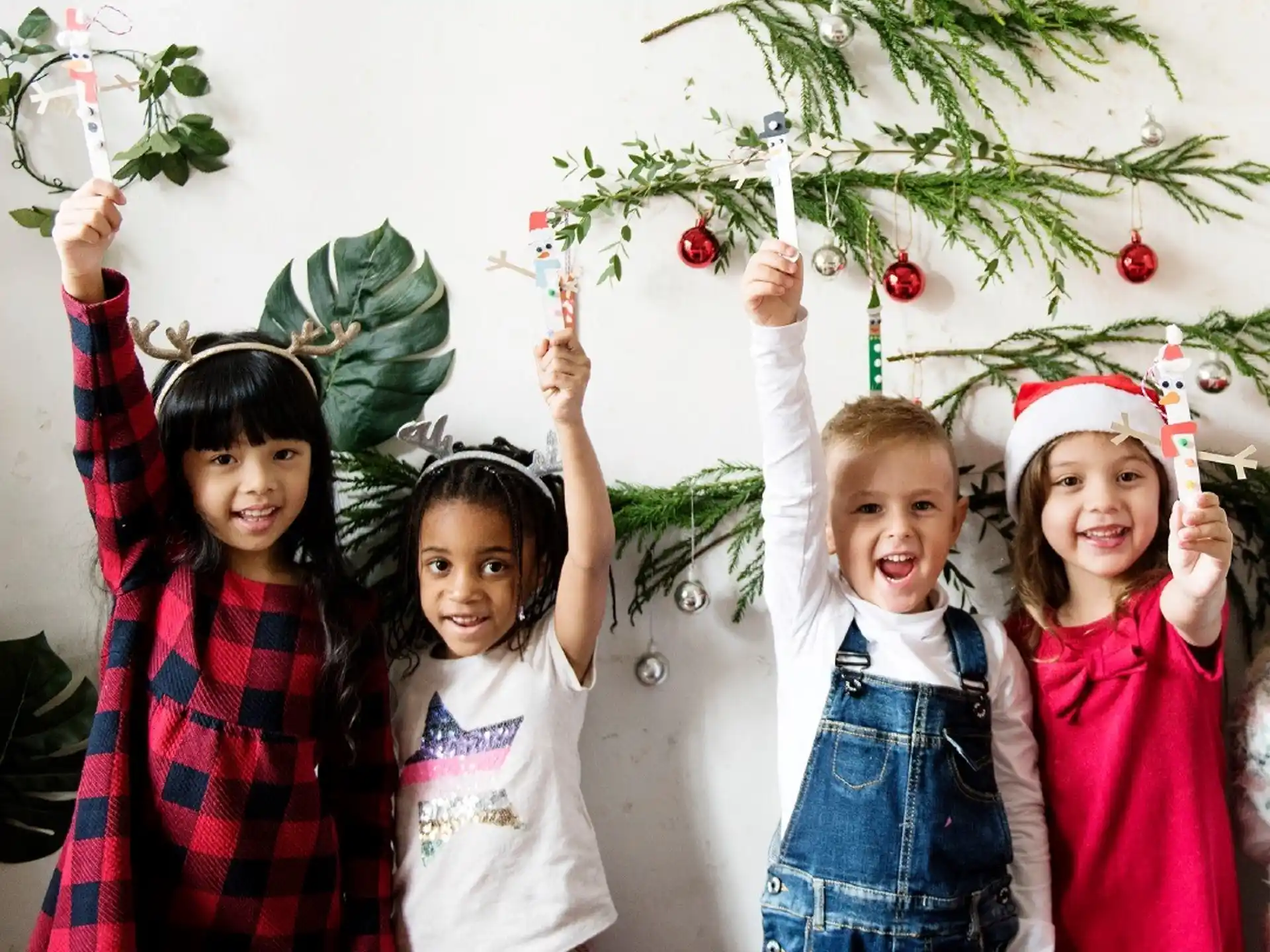 a group of children holding a tree
