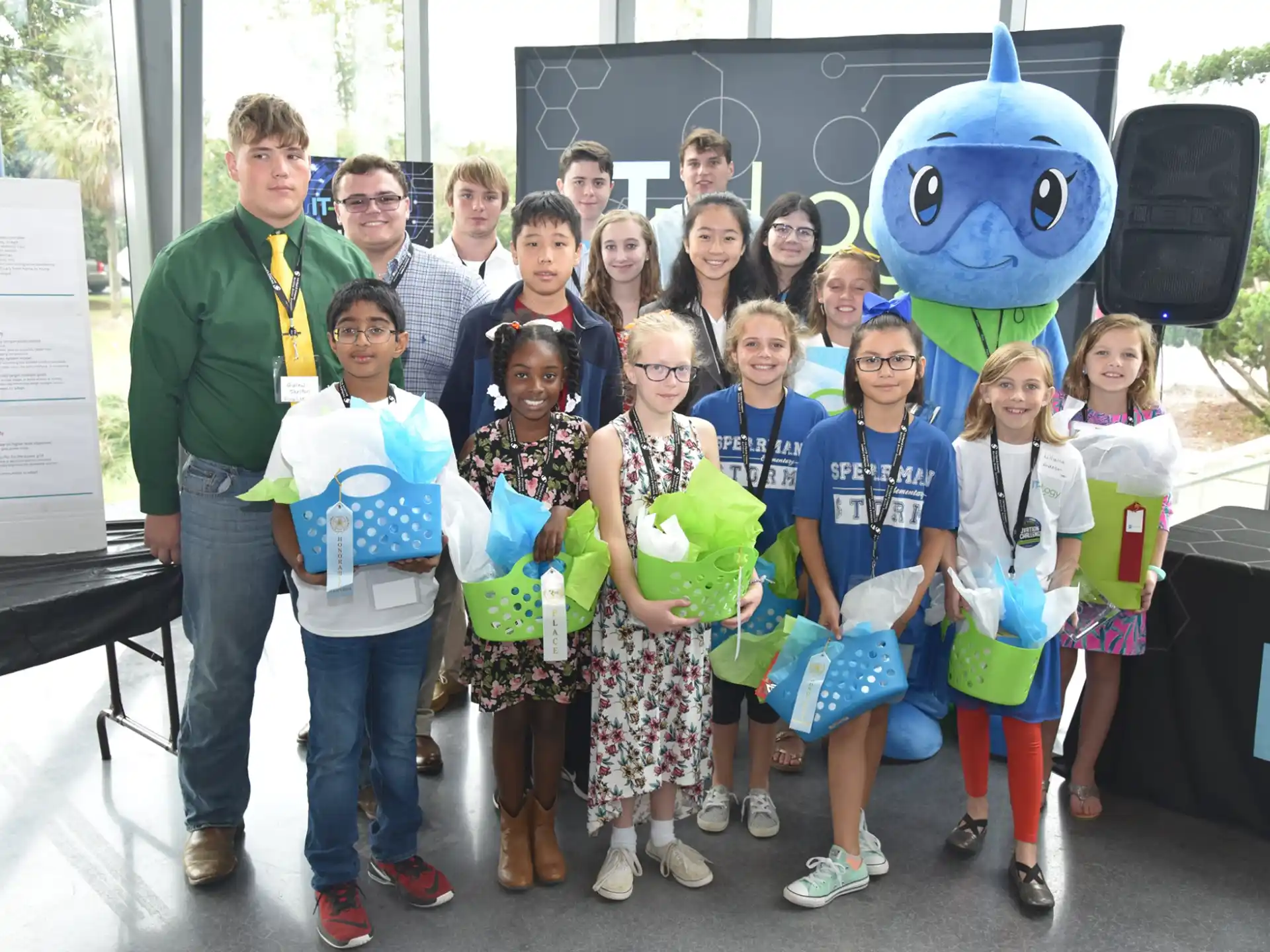 a group of people posing for a photo with a cartoon character