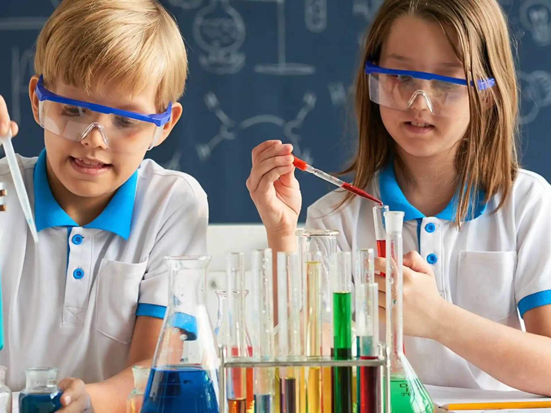 a couple of young children wearing lab coats and eyeglasses
