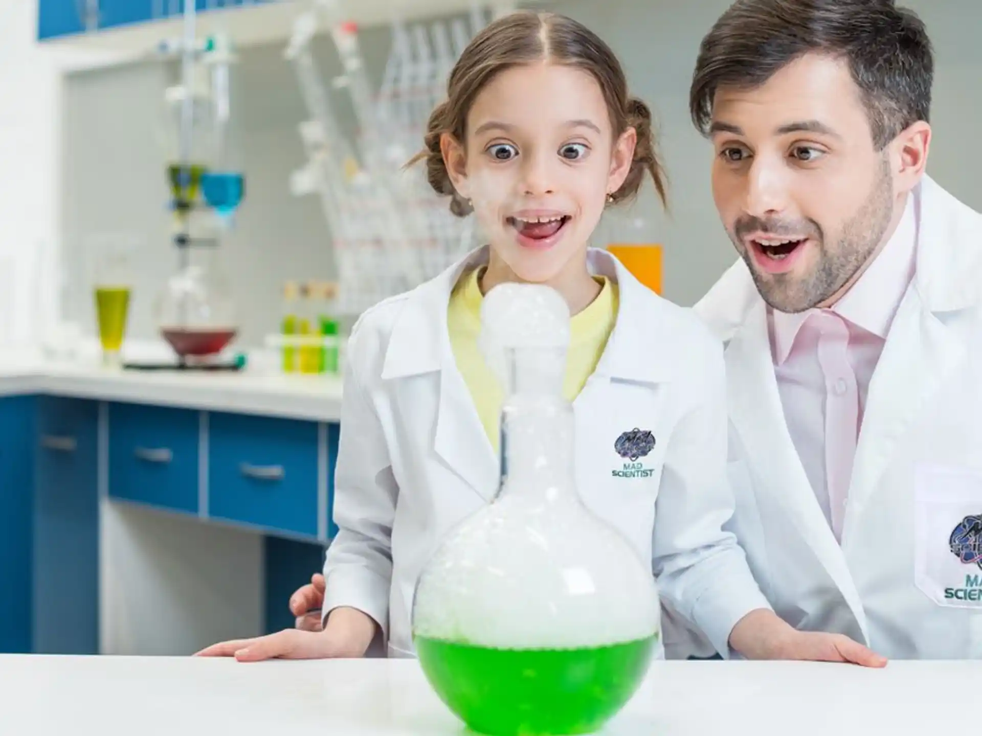 a person and a girl in lab coats