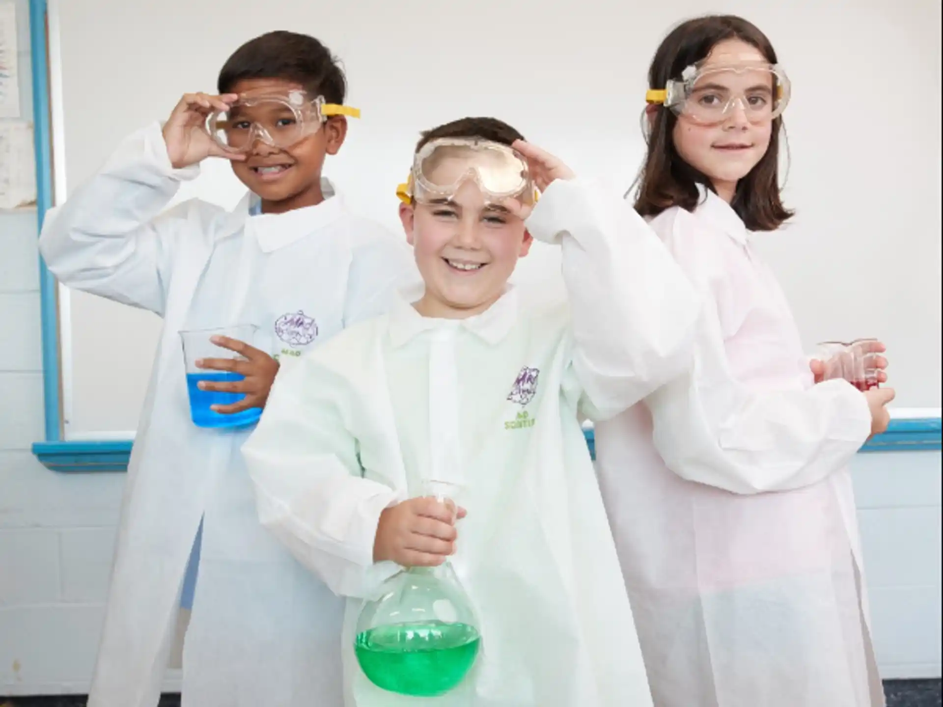 a group of people wearing lab coats and holding beakers