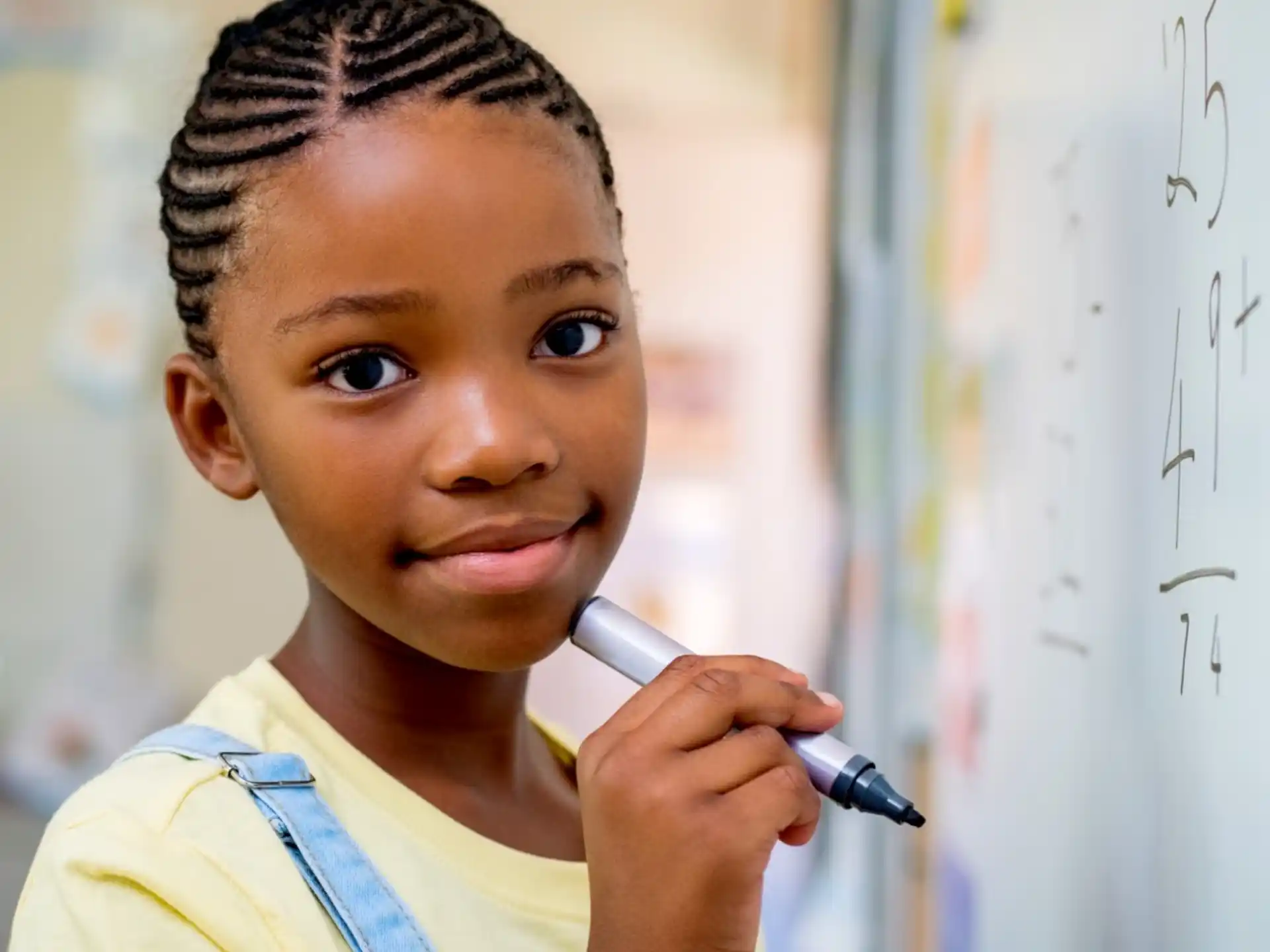 a young woman holding a pen