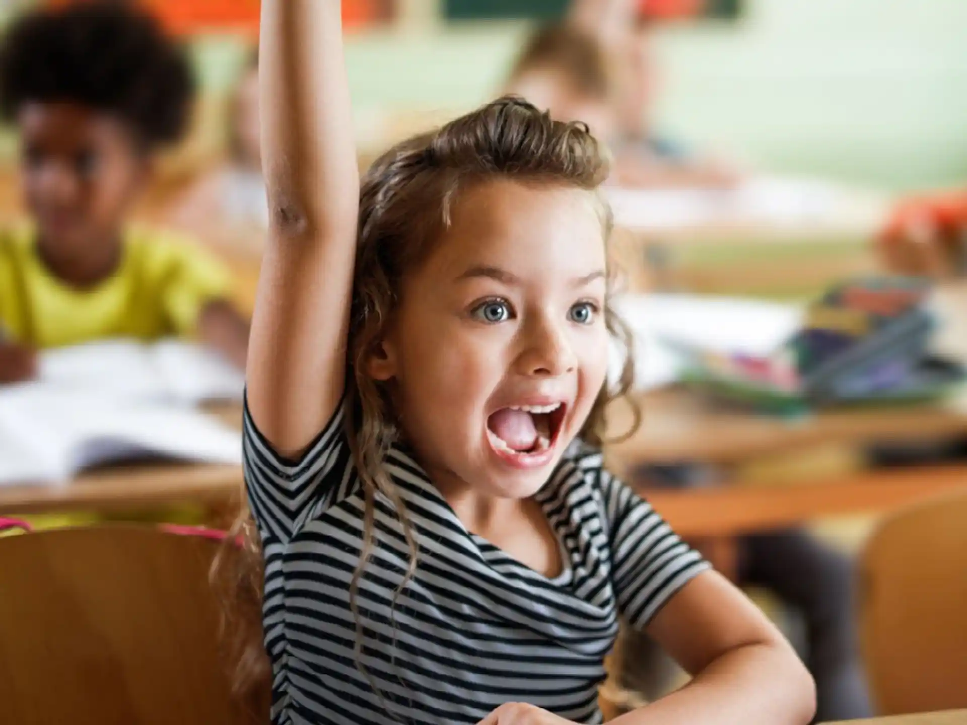 a girl raising her hand