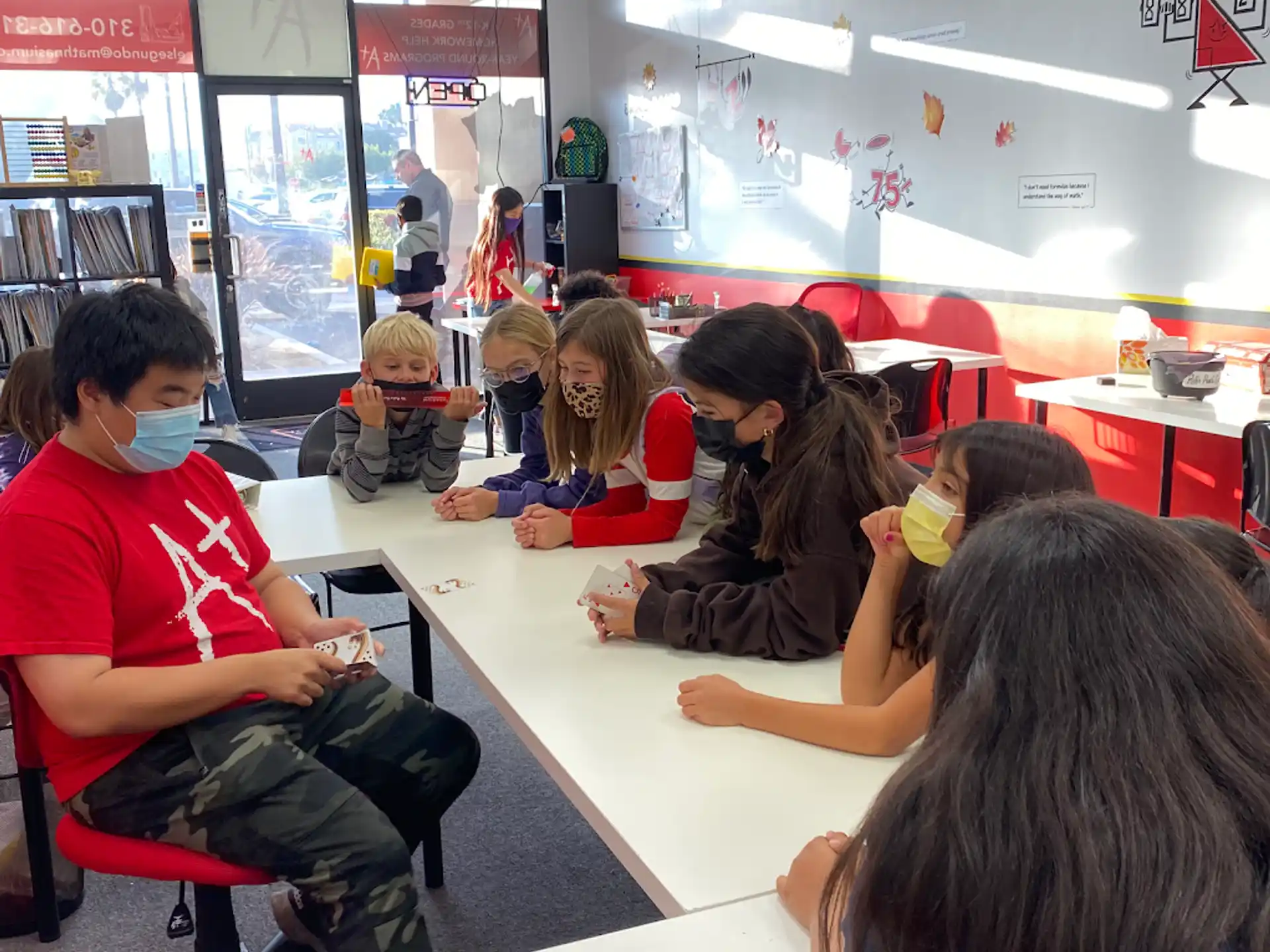 a group of children sitting at desks in a classroom