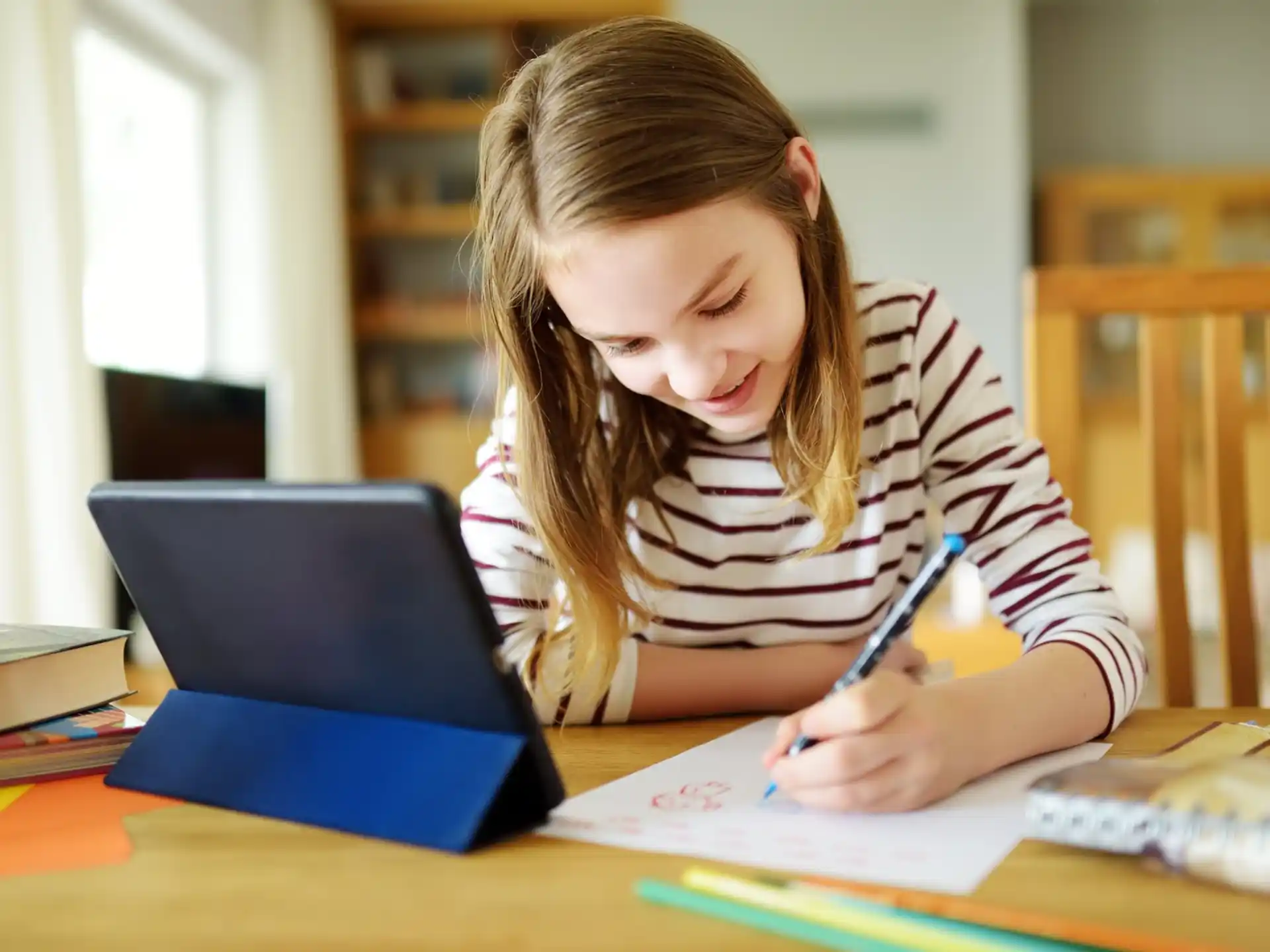 a girl writing on a book