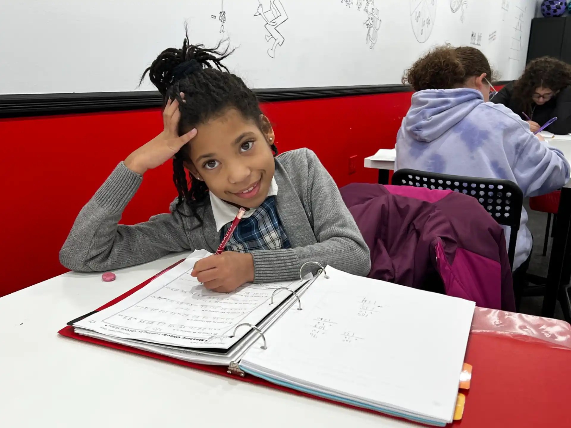 a girl sitting at a desk