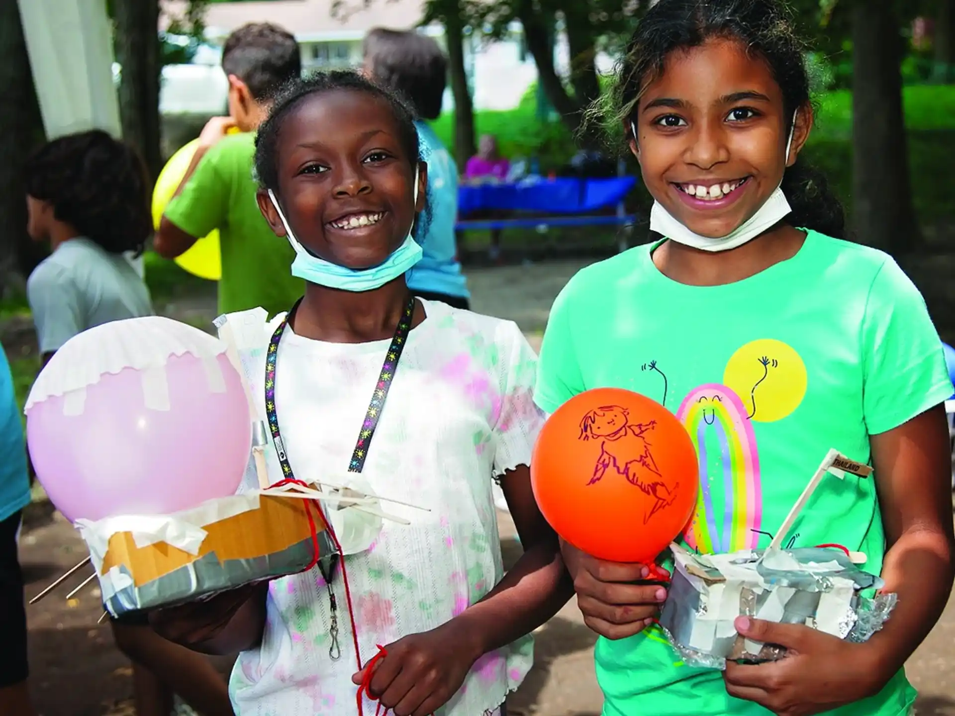 a couple of young girls holding buckets of water