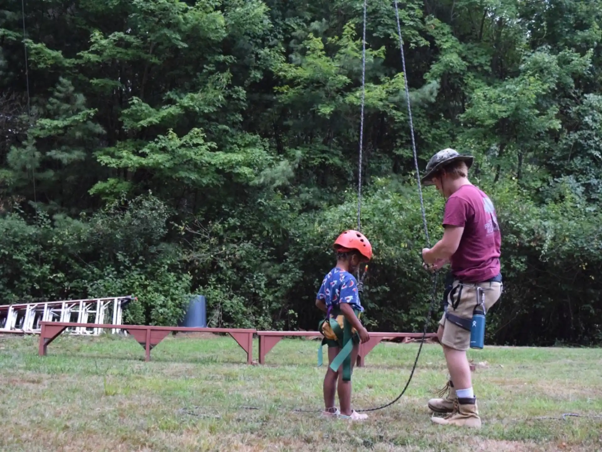 a person and a child on a swing set