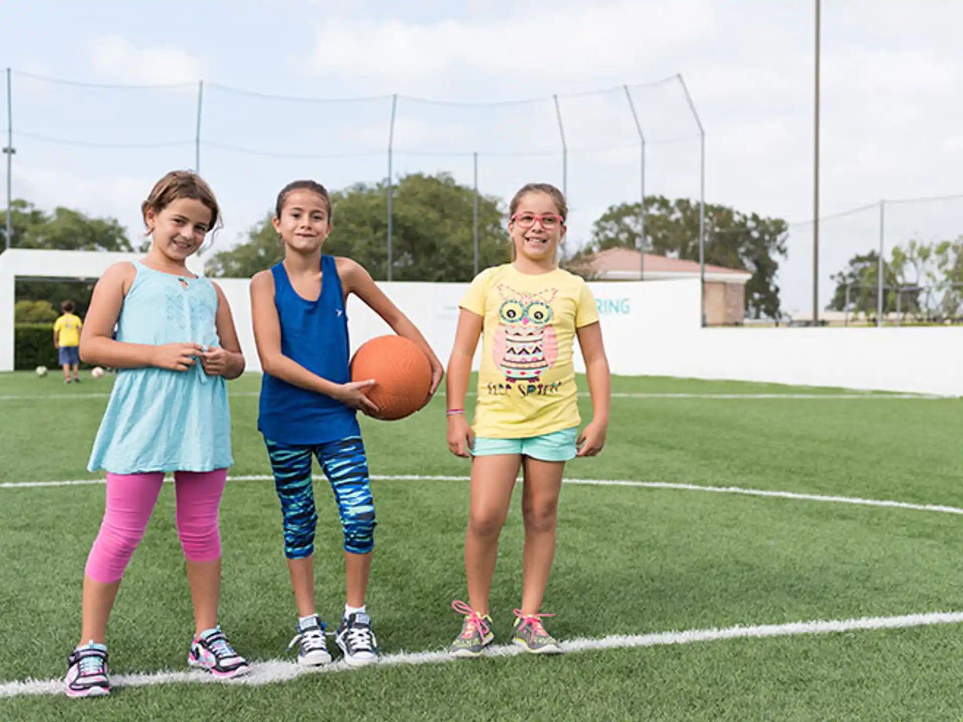 a group of girls holding a basketball