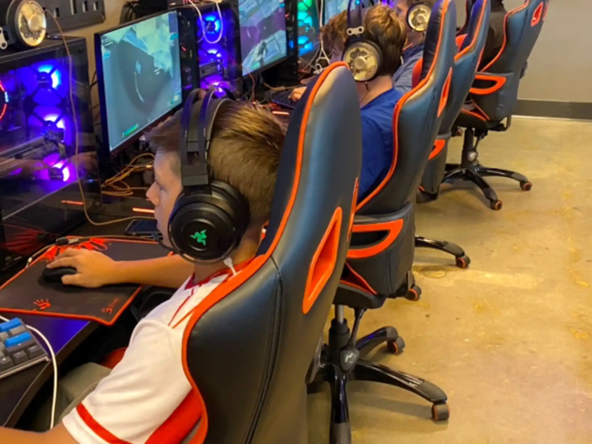 a group of people sitting in front of computers
