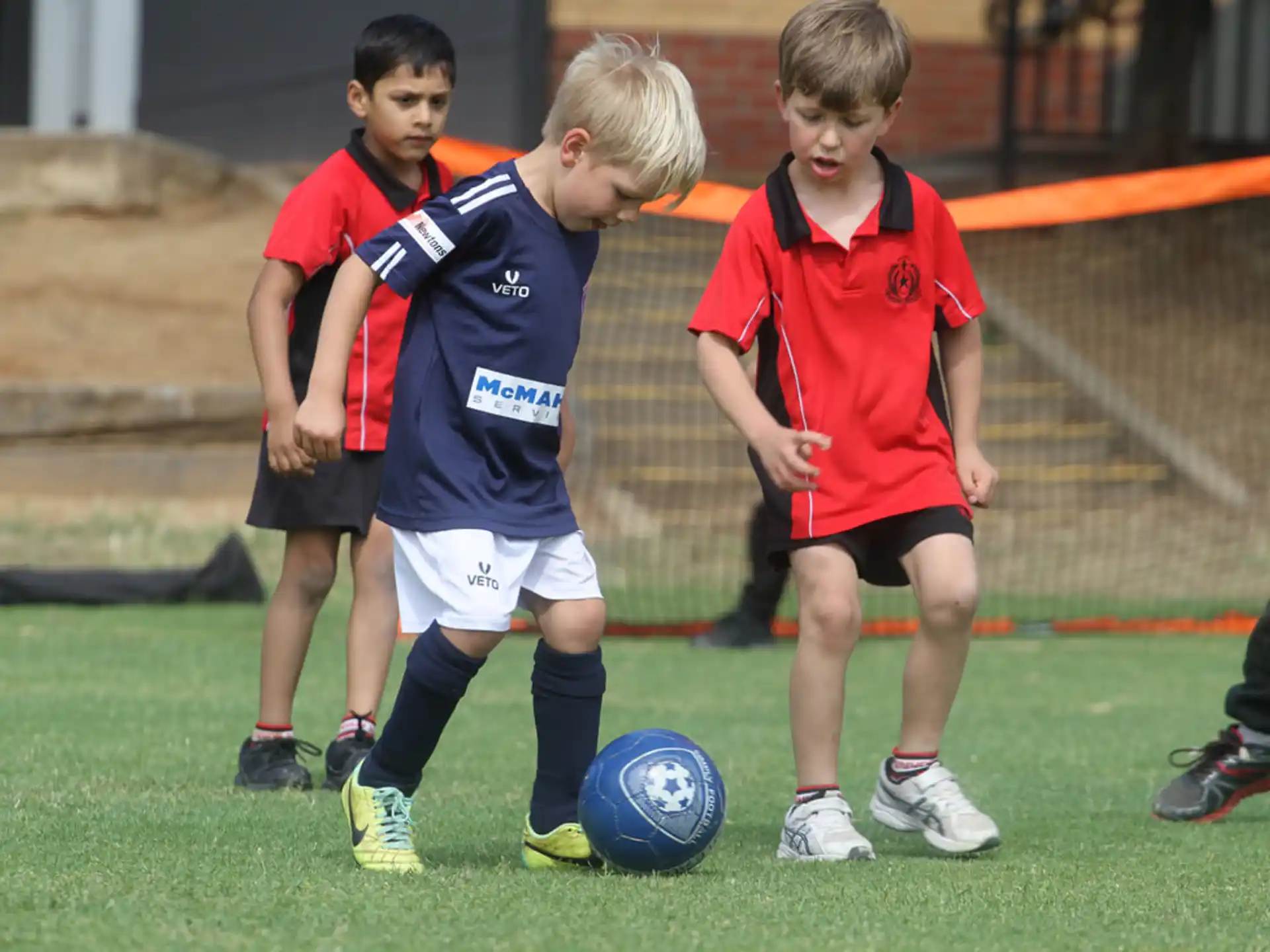 kids playing football on a field
