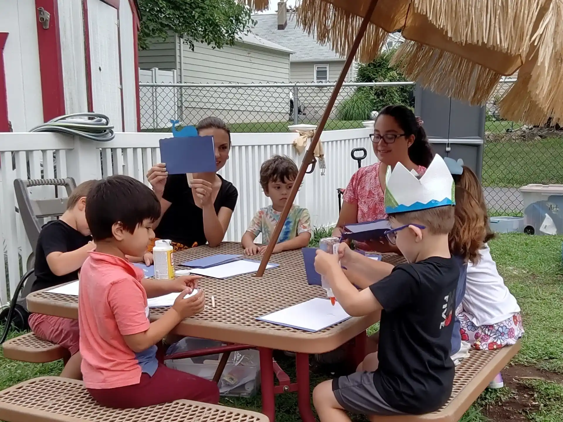 a group of people sitting at a table outside