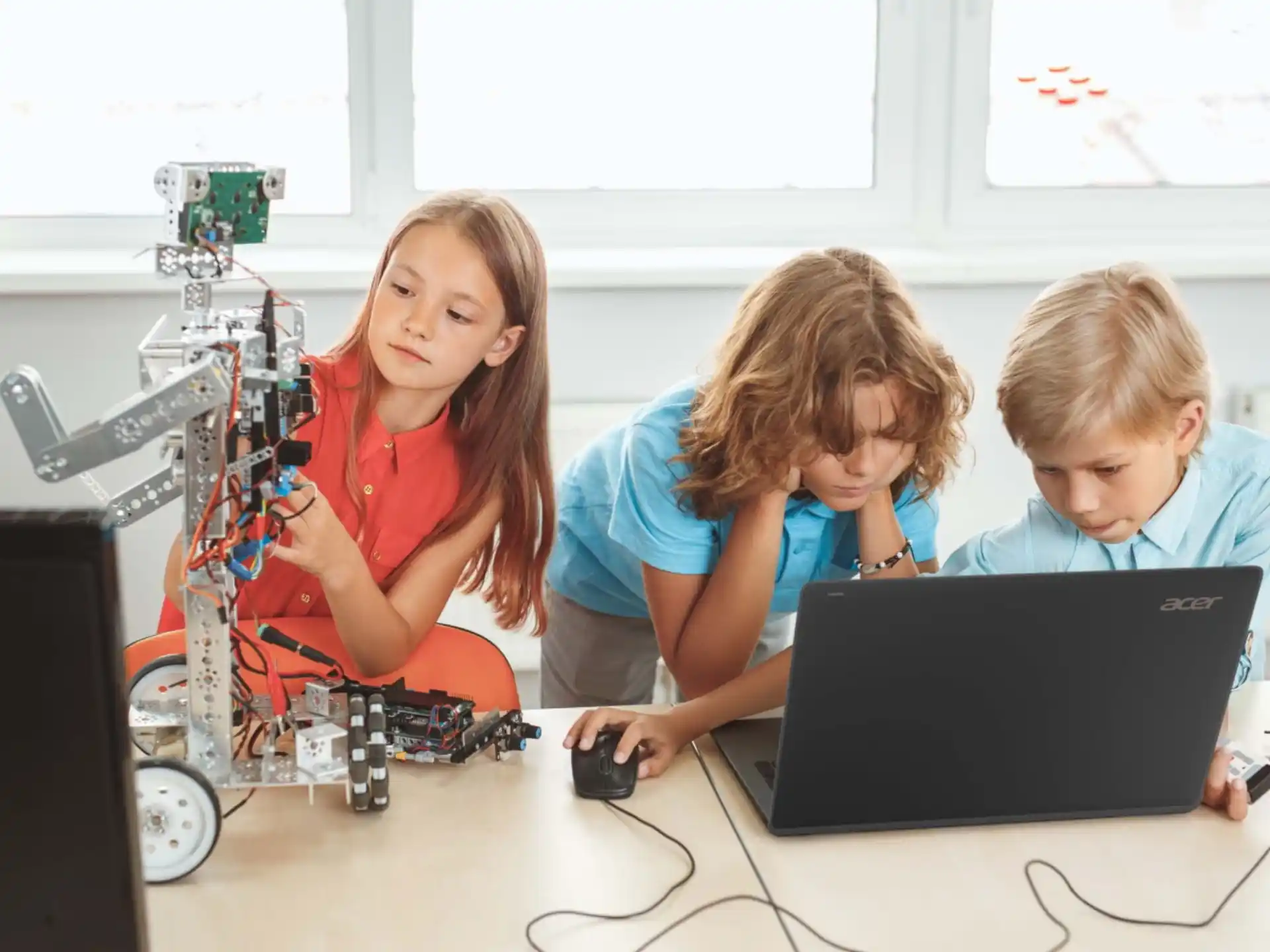 a group of kids working on a computer