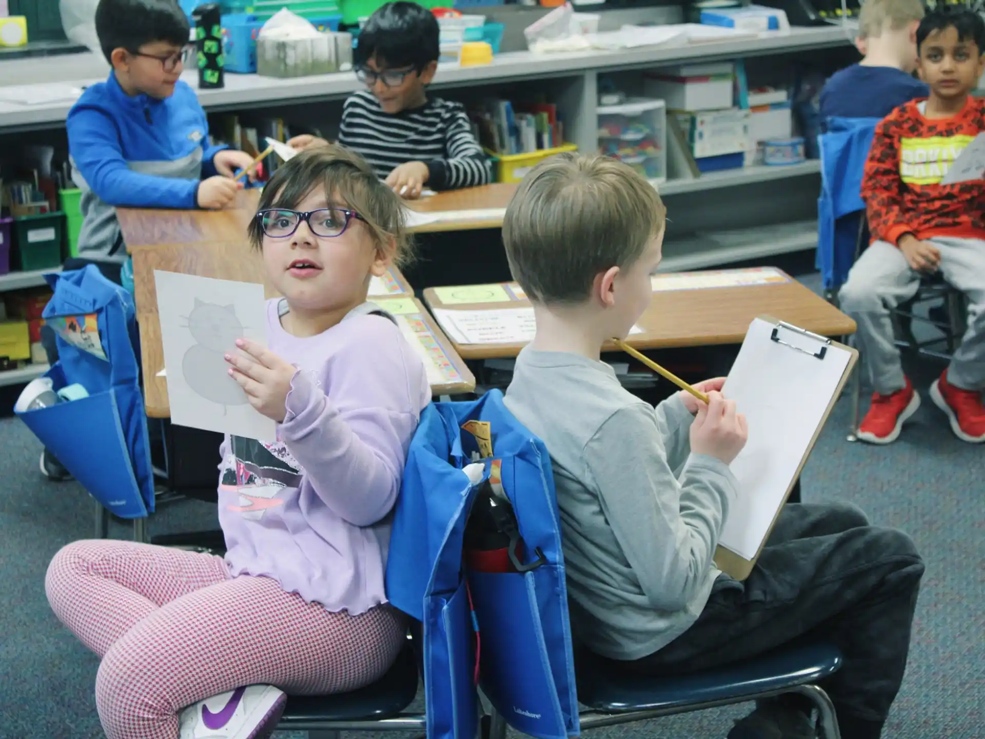 a group of children sitting in chairs