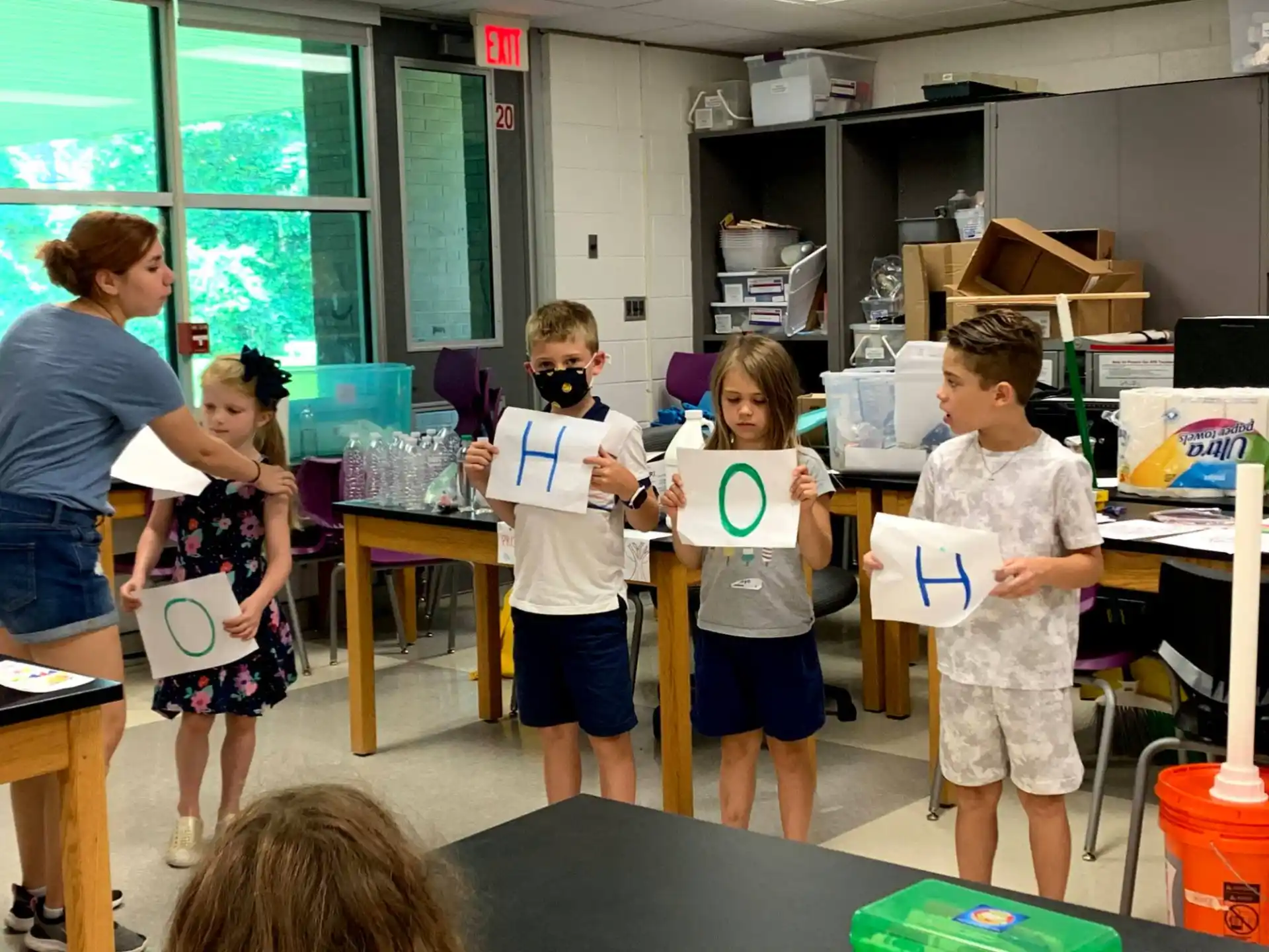 a group of children holding signs