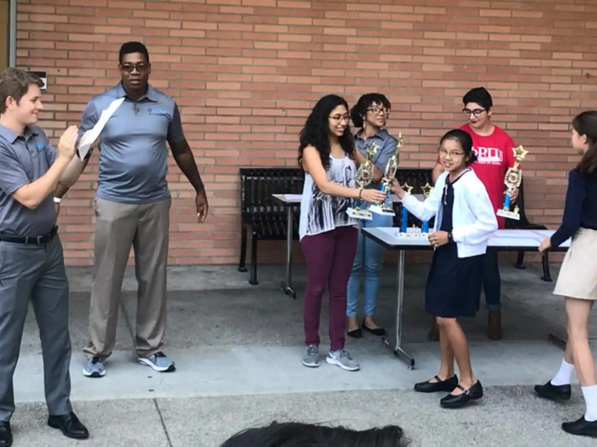 a group of people standing around a table