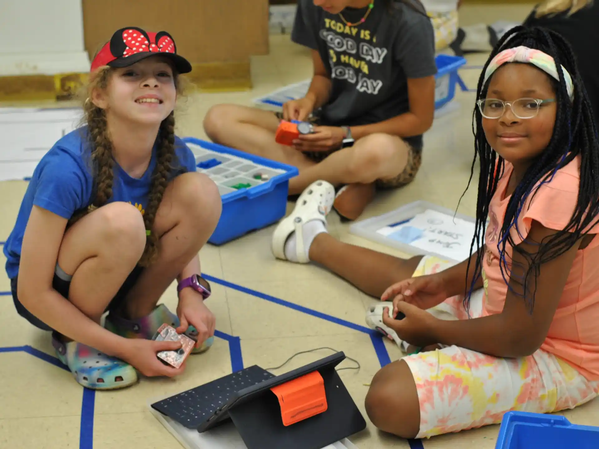 a few young girls sitting on the floor