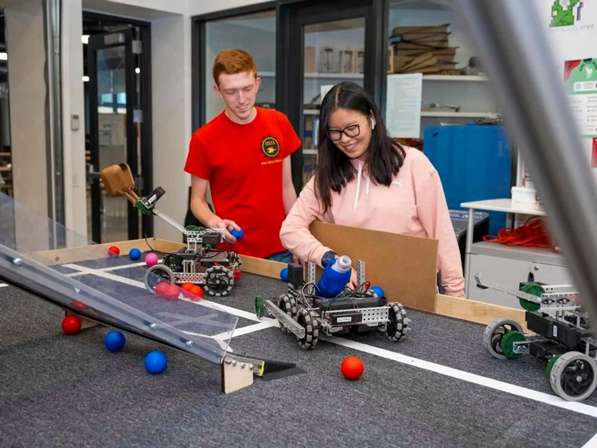 a man and a woman working on a toy car