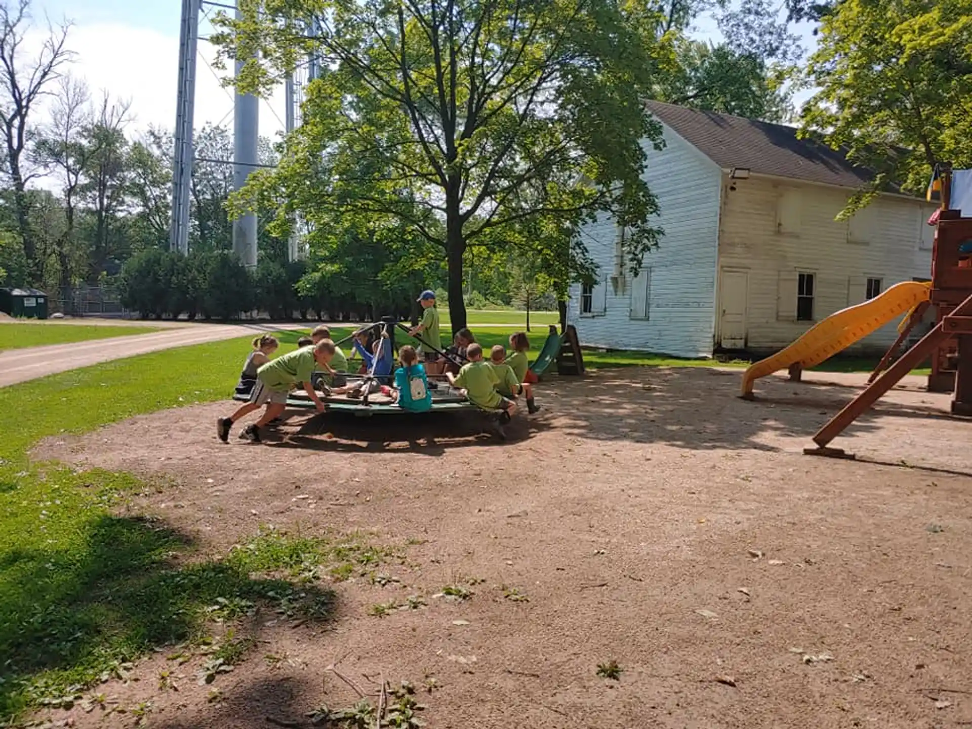 a group of people sitting on a trampoline in a yard