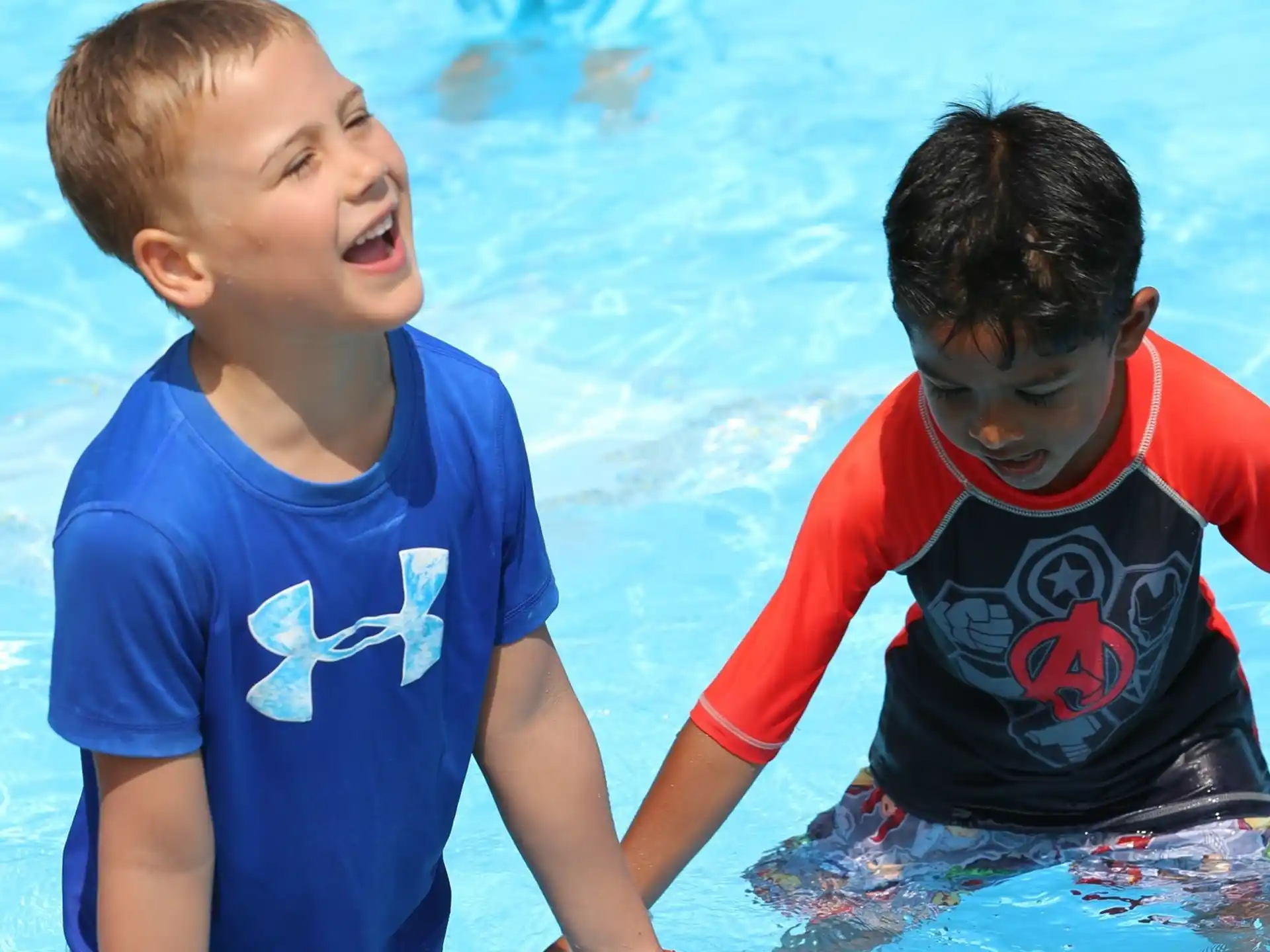 a couple of boys in a pool
